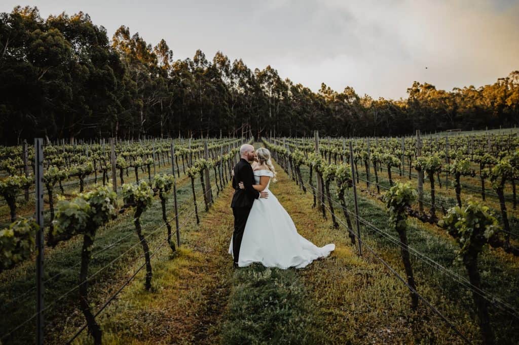 Kelly and Liam share a kiss amongst the vineyard